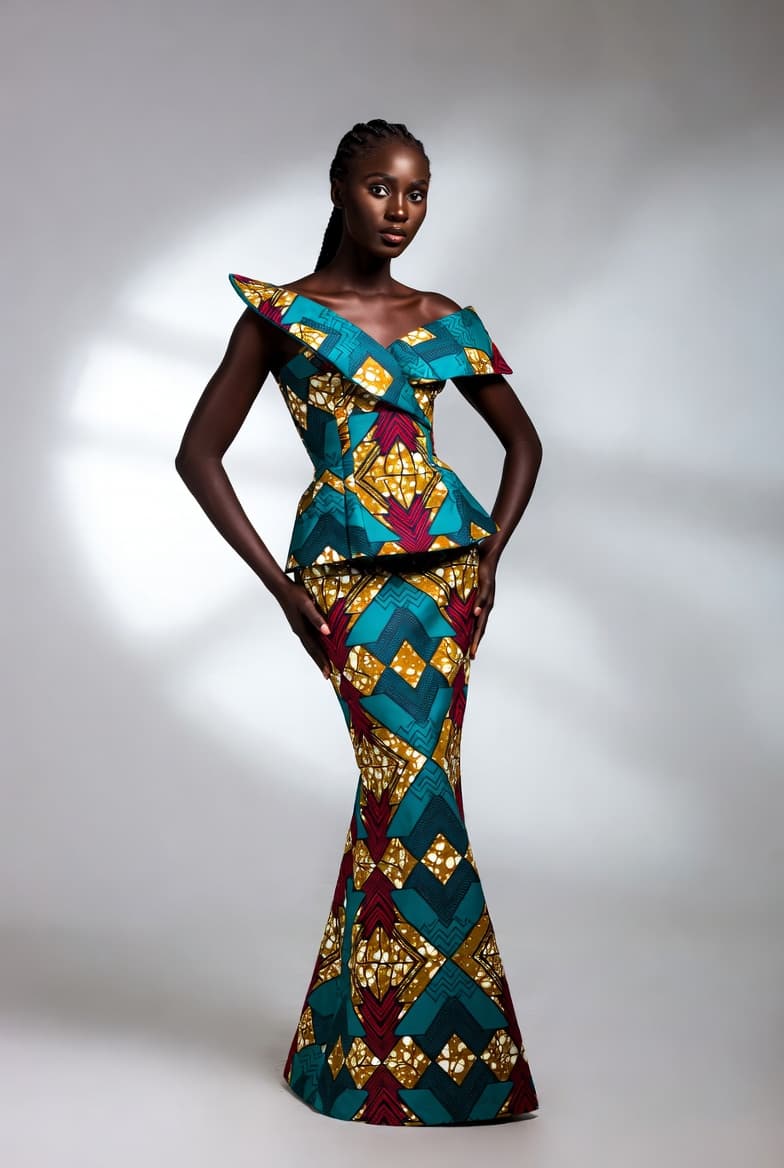 An off-shoulder teal and gold Ankara mermaid gown with peplum